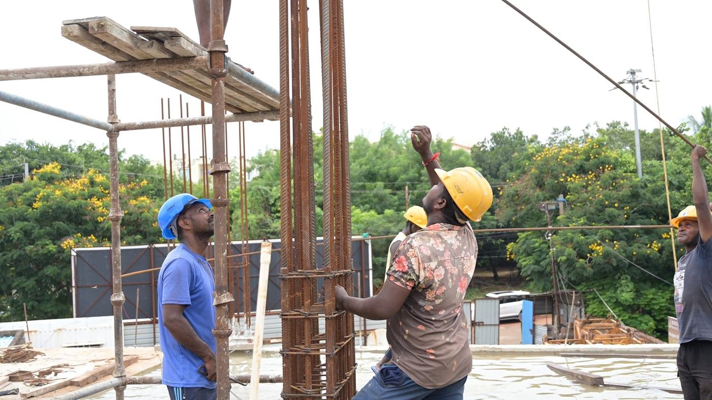 Archid Constructions workers tying steel reinforcement for a column
